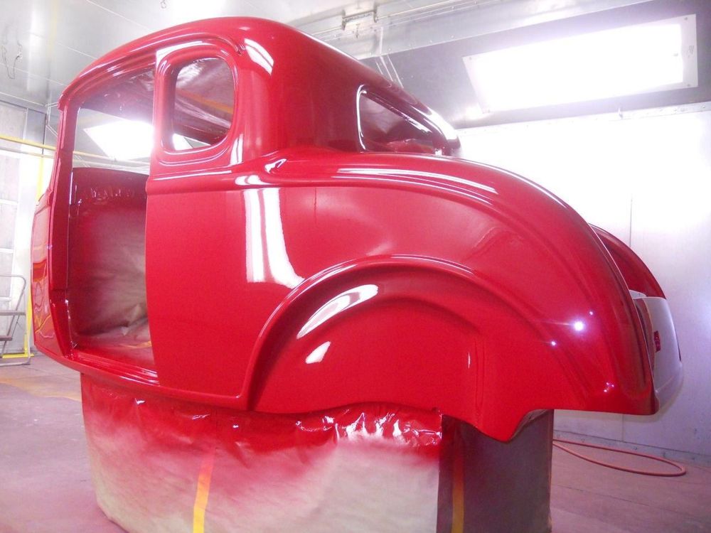 A freshly painted red body shell in the Squeeg’s spray booth