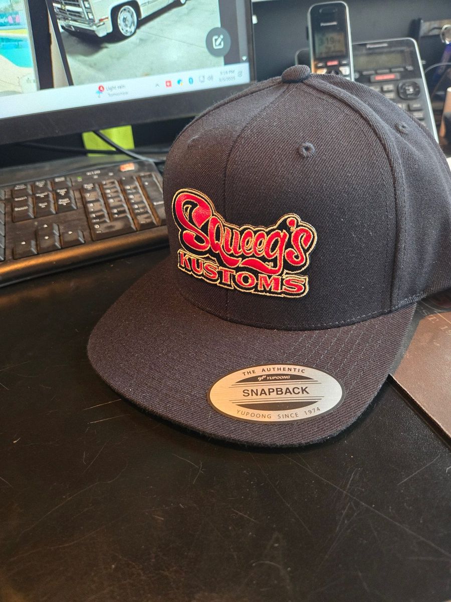 Squeeg’s Kustoms snapback cap with the embroidered script logo